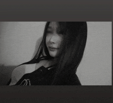 a black and white photo of a young woman with long hair