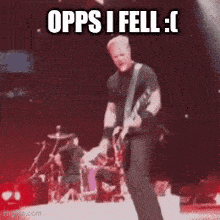 a man is playing a guitar on a stage with the words opps i fell written above him .