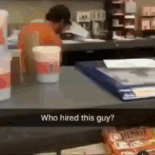 a man is sitting at a counter in a fast food restaurant .