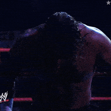 a wrestler in a wrestling ring with a w on his arm