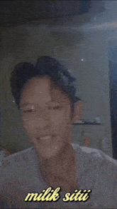 a picture of a young man with the words milik siti written below him