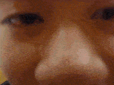 a blurry picture of a person 's face with a yellow background .