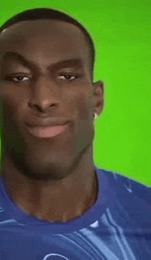a man in a blue shirt is making a funny face .