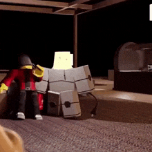 a toy robot is standing on a carpet in a dark room with a person standing next to it .