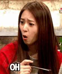 a woman with long hair is holding a chopstick with the word oh on it
