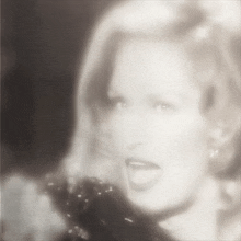 a black and white photo of a woman sticking her tongue out