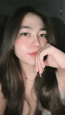 a woman with long nails is taking a selfie