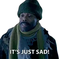 a man wearing a scarf and a beanie says it 's just sad
