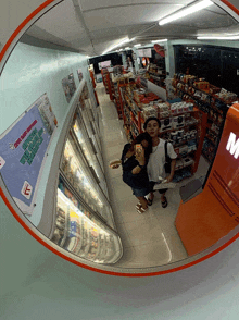 a couple taking a picture in a store with a sign on the wall that says ' open daily '