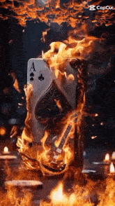a burning ace of spades playing card with a guitar .