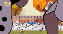 a bunch of dalmatian dogs in a fenced in area with a disney logo on the bottom