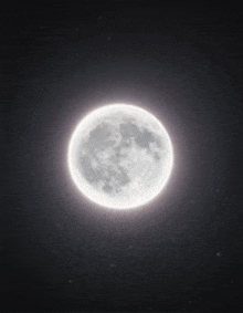 a full moon is shining brightly in the dark night sky