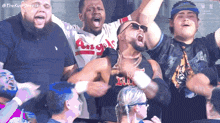 a man in a angels shirt is surrounded by fans