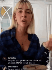 a woman in a blue plaid shirt is talking about why she got kicked out of the vs