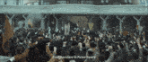 a crowd of people with their hands in the air with the words from navishare to palmo square