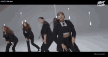 a group of women are dancing in front of a sign that says ' honeycam.org '