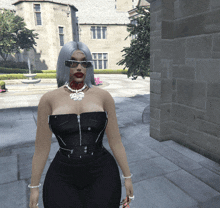 a woman wearing sunglasses and a necklace is standing in front of a brick building