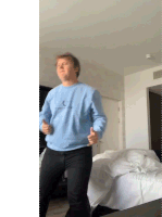 a man wearing a blue sweatshirt that says " i love you " on it