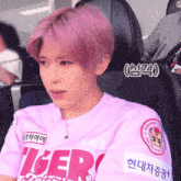 a girl with pink hair is wearing a shirt that says tiger on it