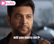 a man with a beard is asking will you marry me .
