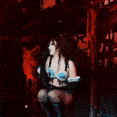 a woman singing into a microphone while kneeling down