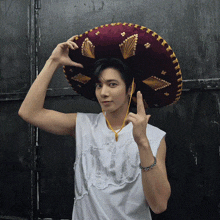 a man wearing a sombrero and a white shirt that says ' who ' on it