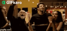 a group of people are dancing together in a room with their hands in the air .