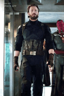 a man in a captain america costume is standing in a hallway next to a vision statue .
