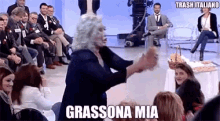 a woman in a wig is dancing in front of a crowd and the caption says grassona mia
