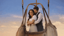 a man and woman in a hot air balloon
