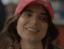 a woman is wearing a pink hat that says art baby