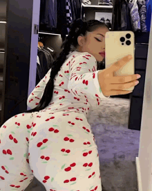 a woman taking a selfie in a mirror with her phone