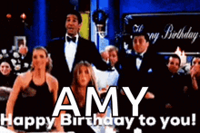 a group of people are standing in front of a sign that says happy birthday to you