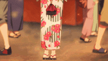 a woman in a floral kimono stands in a crowd of people