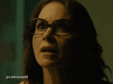 a close up of a woman wearing glasses with the hashtag lialmeida05 below her