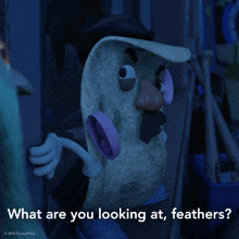 a picture of mr. potato head from toy story with the caption what are you looking at feathers