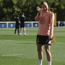 a woman wearing a shirt with the number 3 on it