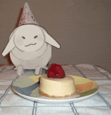 a cardboard bunny wearing a party hat is standing next to a plate of food