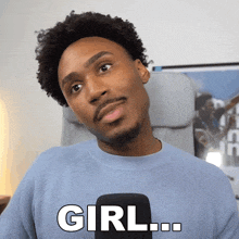a man is wearing a blue sweater that says girl on it