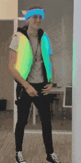 a man wearing a glow in the dark vest and a blue headband