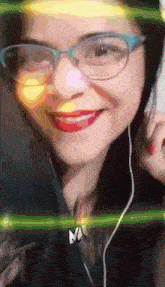 a woman wearing glasses and ear buds is smiling