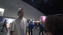 a man with a lanyard that says ' disney ' on it