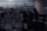 a blurry picture of a group of people standing in a room