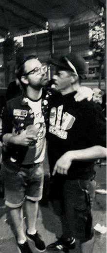 two men standing next to each other with one wearing a shirt that says ' 39 ' on the front