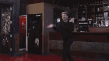 a blurry photo of a man dancing in front of a counter
