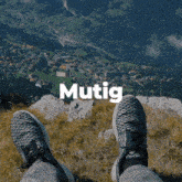 a person laying on a mountain with the word mutig above them