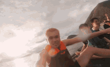 a man wearing a life jacket is sitting on a boat