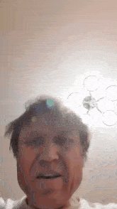a close up of a man 's face with a drone flying overhead