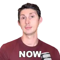a man wearing a red shirt that says now