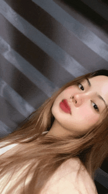 a close up of a woman 's face with red lipstick on her lips